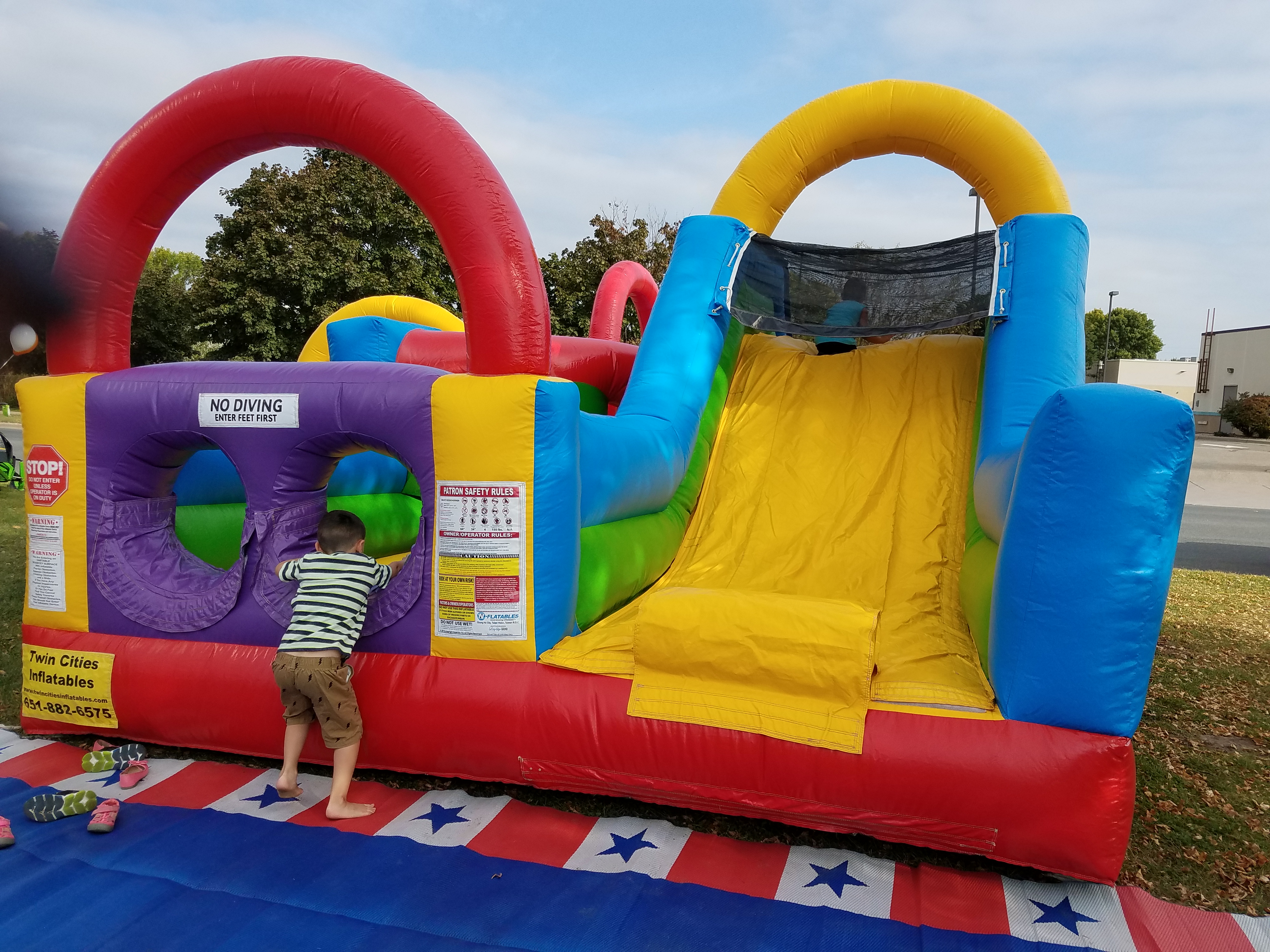 Kids playing in a bounce house at the 2017 Lighhouse Motorsports & Marine open house