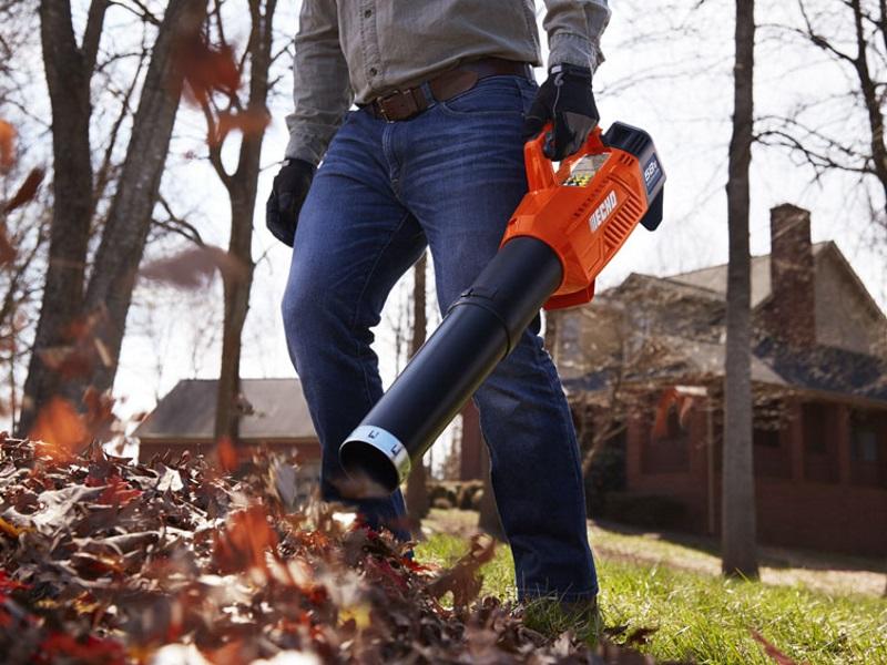 Man using ECHO blower to blow leaves