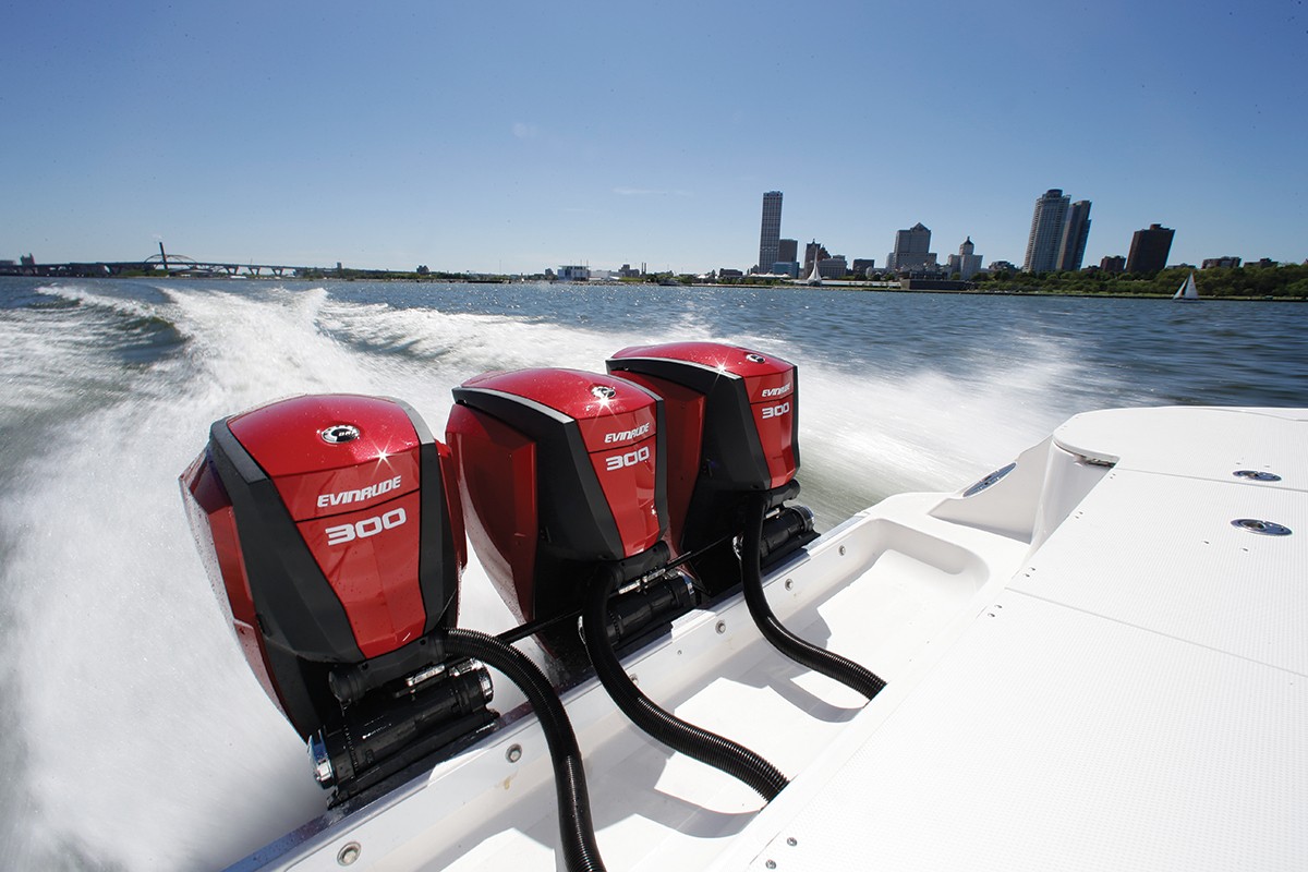 Shot of three Evinrude engines moving a boat real fast