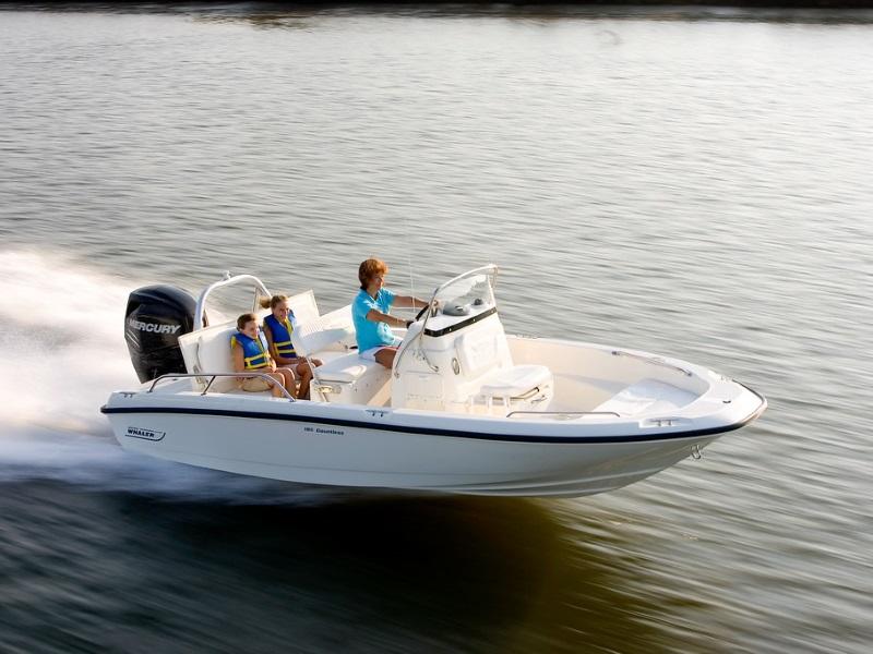 A mother and her two kids speed over the water on a Boston Whaler® 180 Dauntless boat.