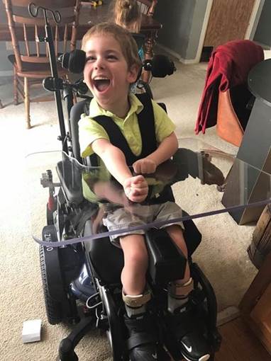 Young boy in custom wheelchair