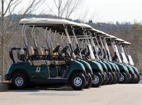 A whole row of Club Car Green Golf Carts