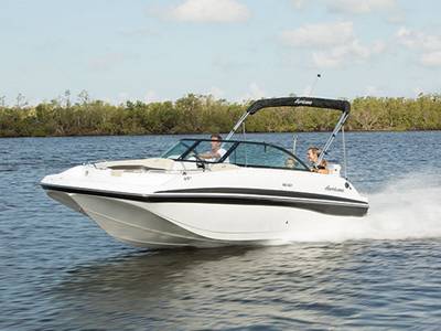 A family of three speed over the water in a Hurricane SD 187 OB deck boat.